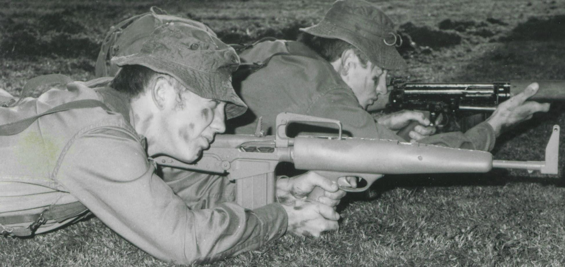 Extremely stable prone position with two hands on pistol grip, firing left handed